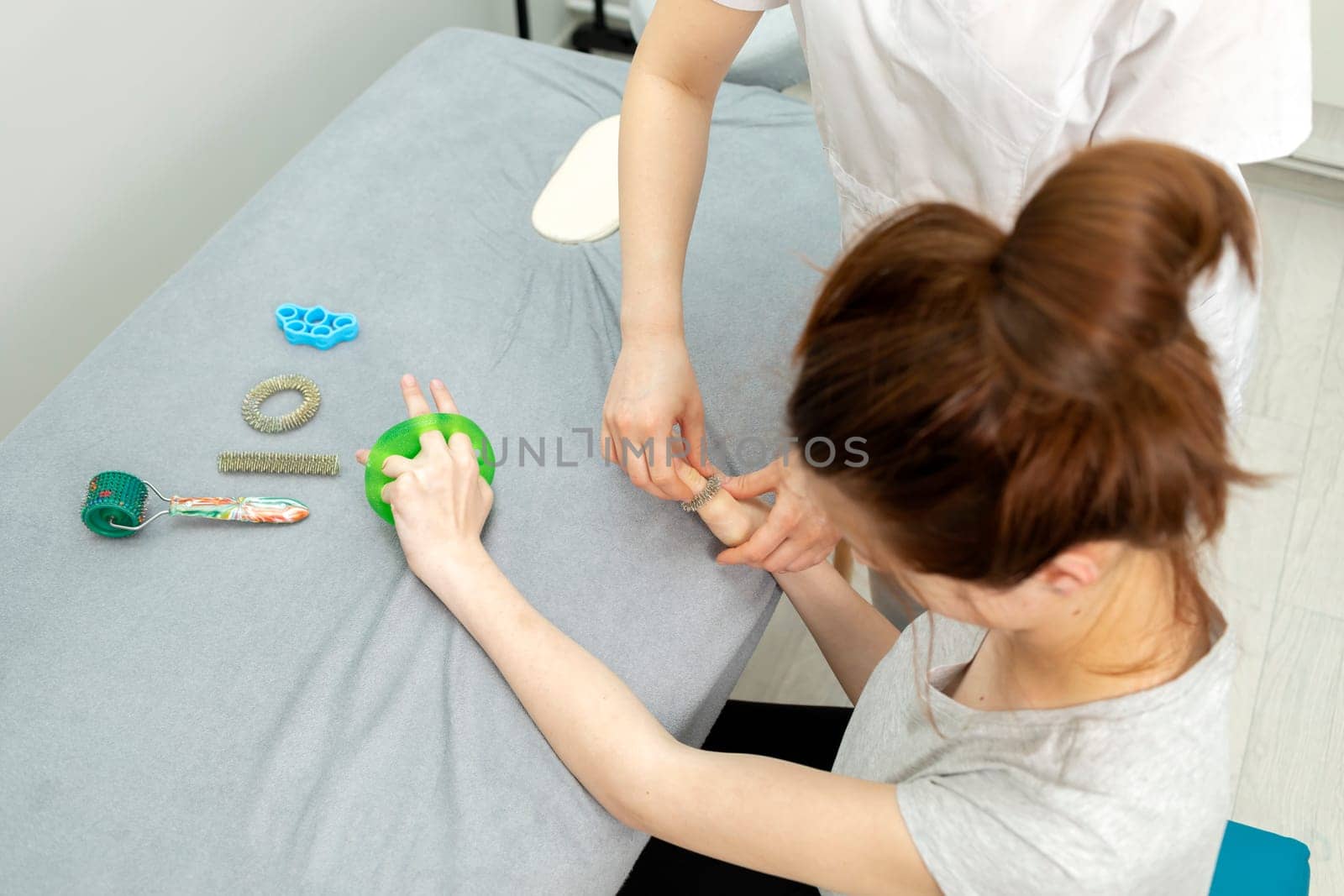 Doctor Neurologist Stretches Fingers Of Child with Disability. Physical Therapy Equipment, Cerebral Palsy, Athetosis. Health Specialist, Rehabilitation. Horizontal plane.