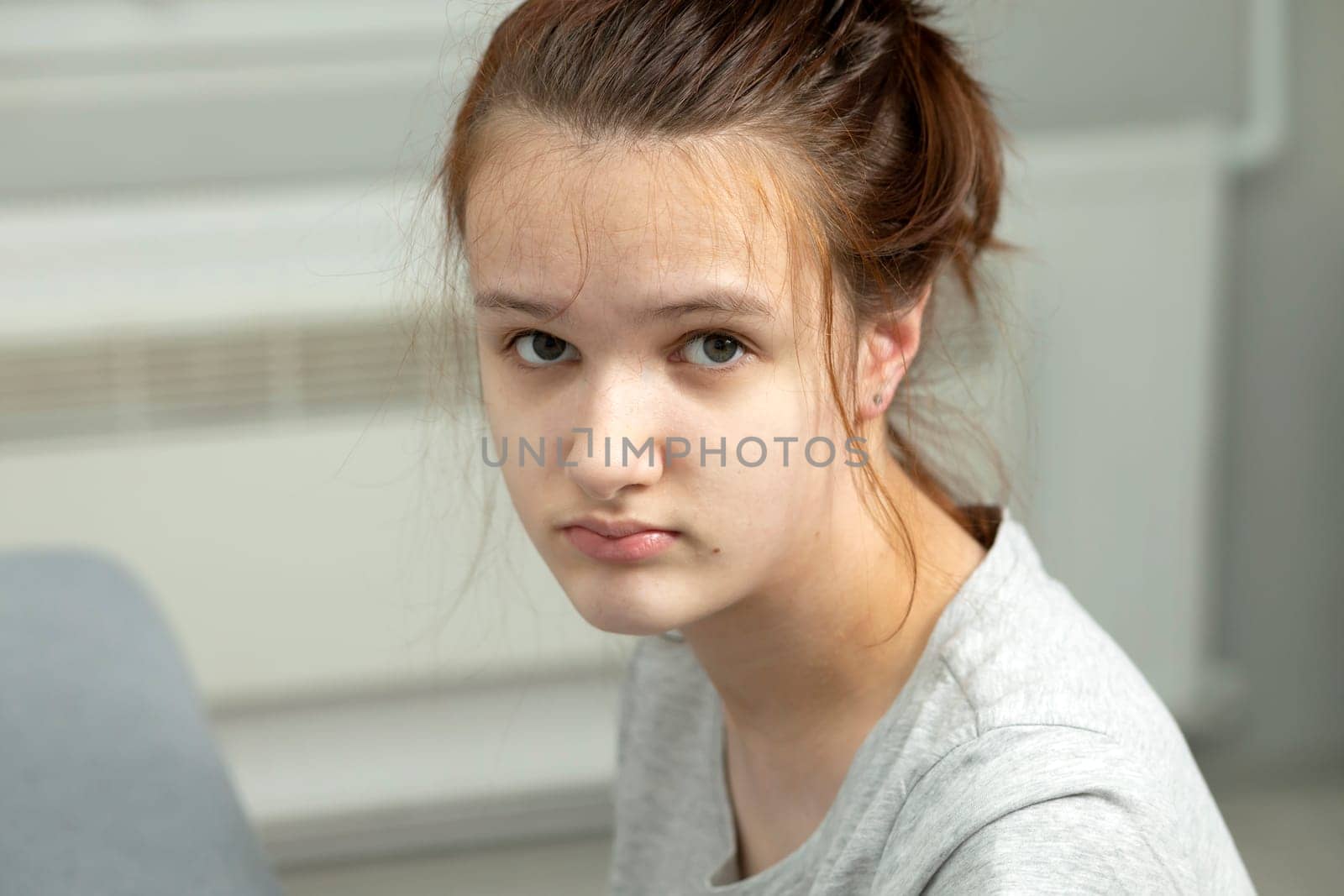 Portrait Of Sad Child, Girl With Disability in Hospital Looking At Camera. Rehabilitation. Cerebral Palsy, Cure. Horizontal plane. High quality photo