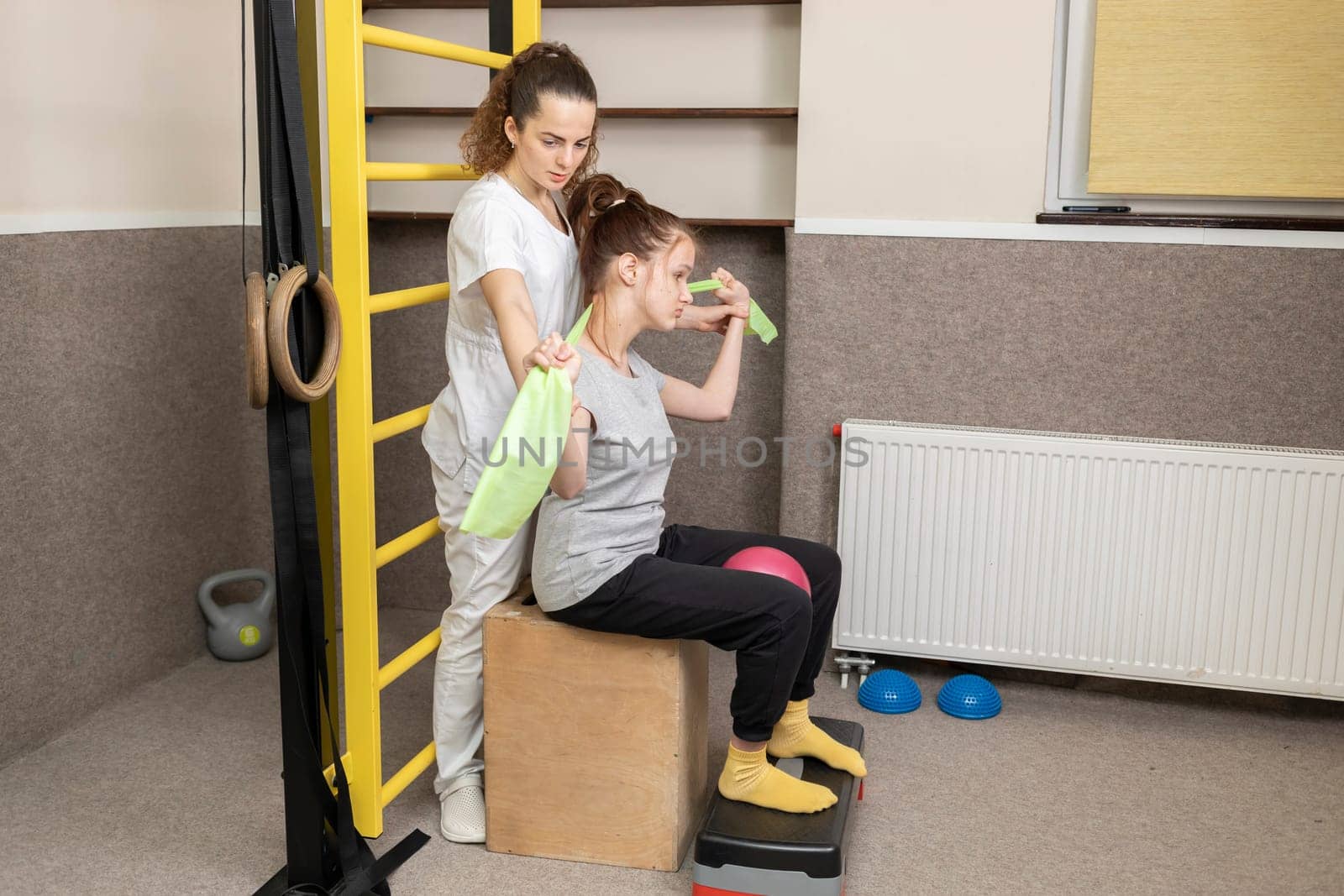 Disabled Child With Doctor Does Physical Exercises In Rehabilitation Room. Kid With Special Needs. Rehabilitation. Cerebral Palsy. Motor Disorder. Horizontal plane. High quality photo