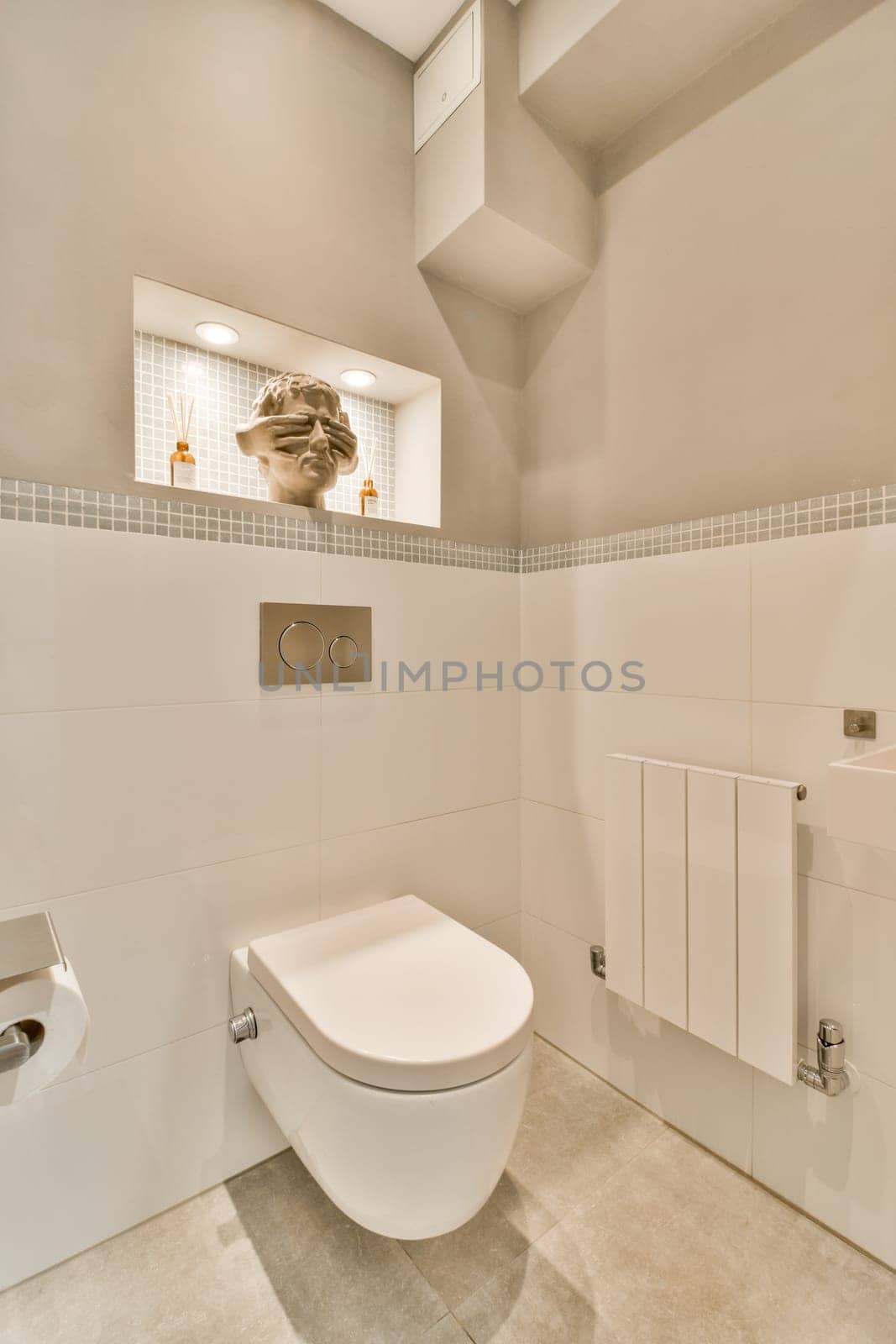 a white bathroom with a toilet and a mirror above by casamedia
