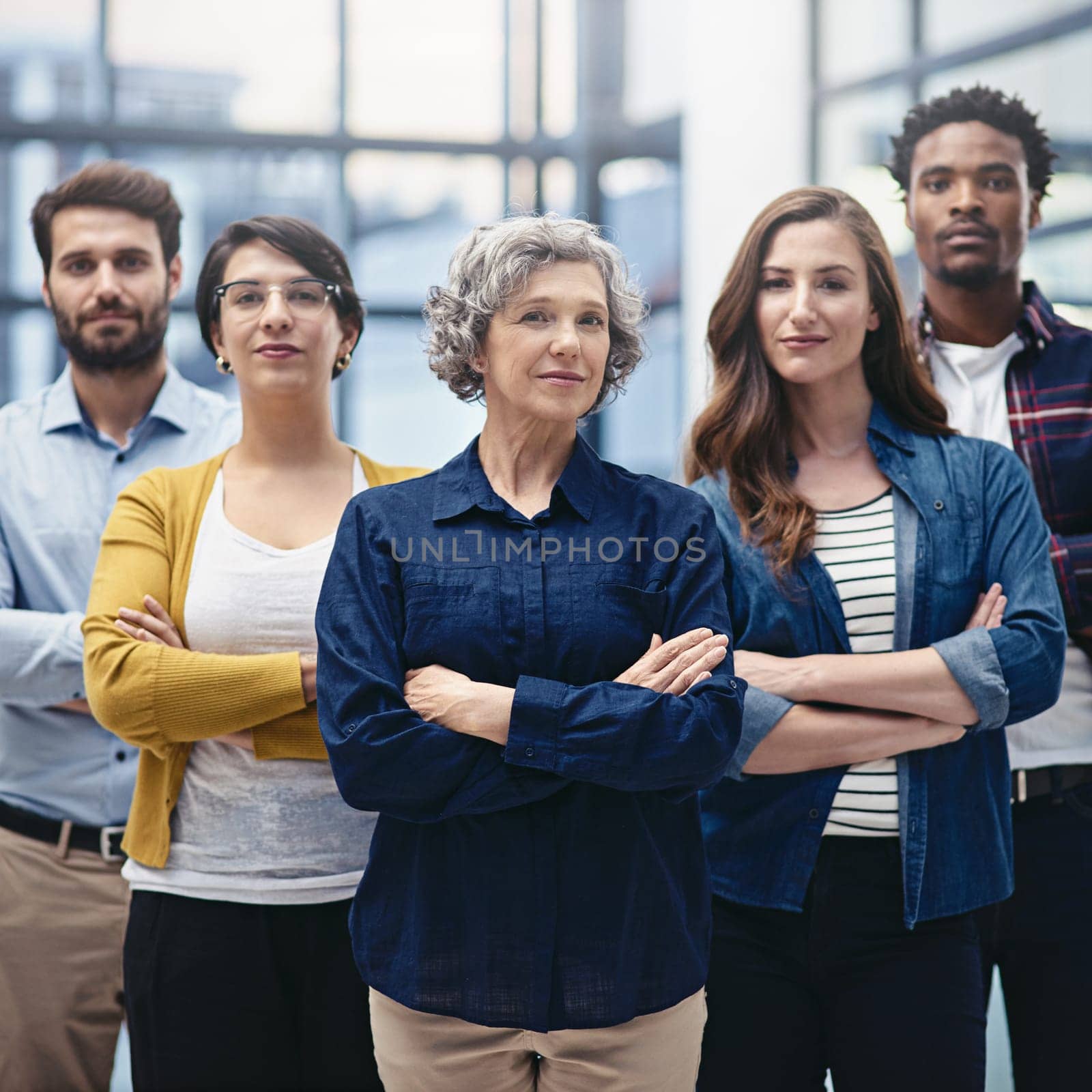 Team, leadership and portrait of business people with crossed arms in the office with confidence. Happy, collaboration and group of multiracial corporate employees with female manager in workplace