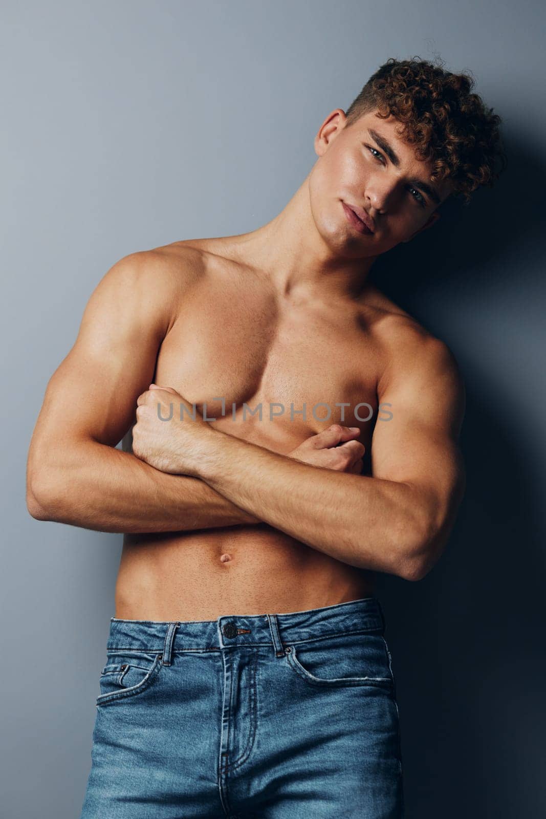 man healthy attractive smile standing shirtless torso fashion jeans athlete beauty young sport by SHOTPRIME
