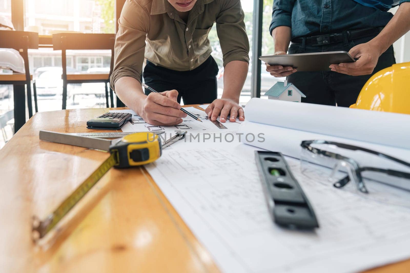 engineer working in office with blueprints, inspection in workplace for architectural plan, construction project ,Business construction.