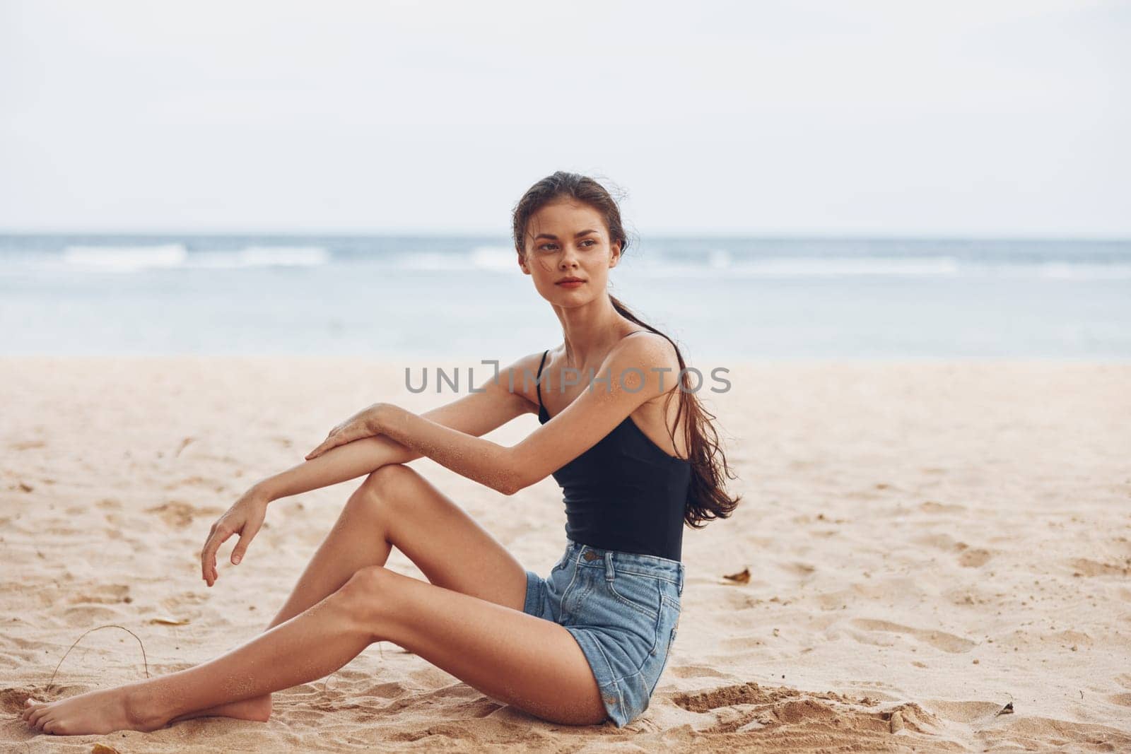 woman girl travel beach vacation coast carefree sexy sitting view sand alone model freedom nature natural sea hair water back attractive smile