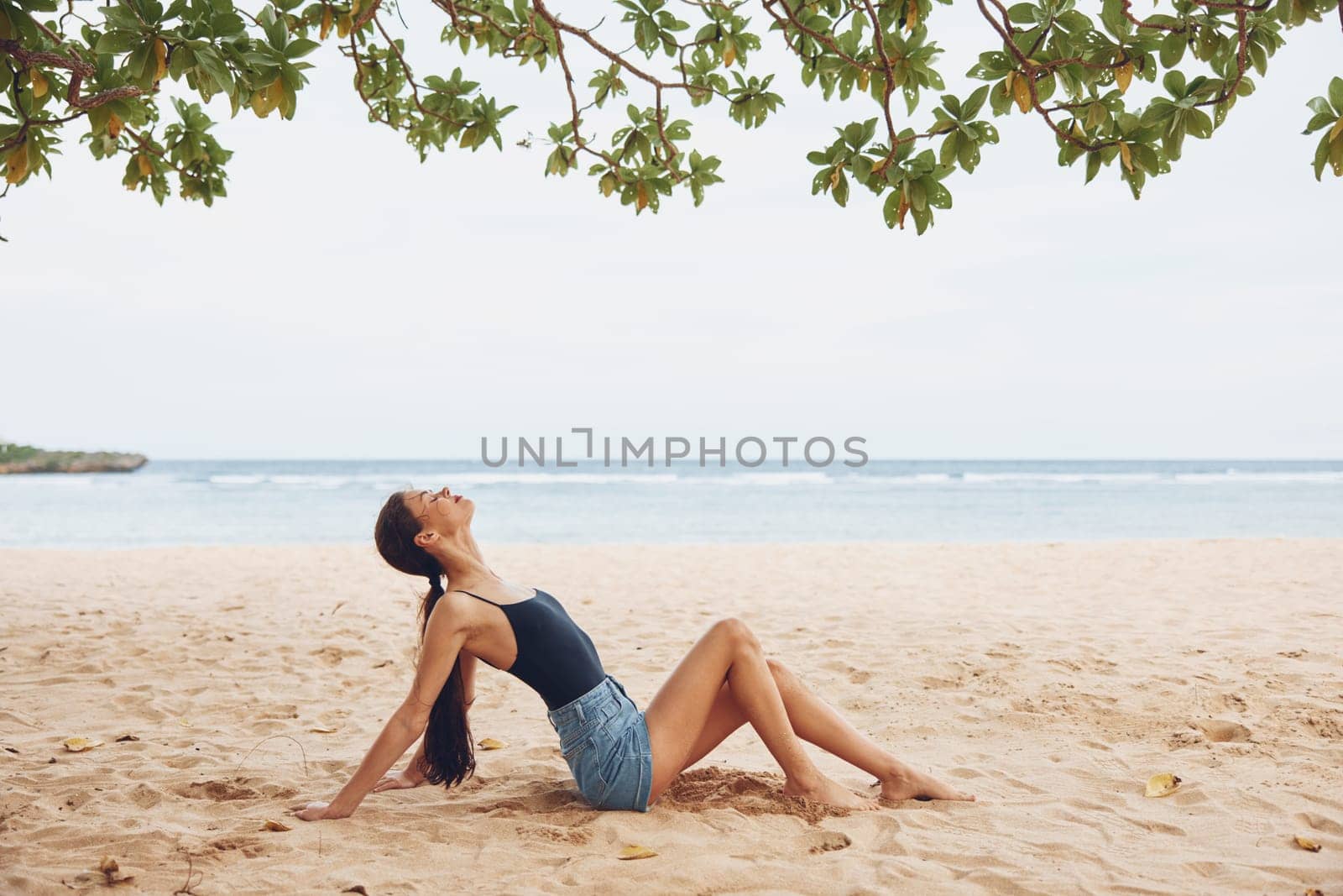 smile woman female beach sea view sitting hair natural long back nature young travel ocean water sand caucasian vacation girl freedom body outdoor