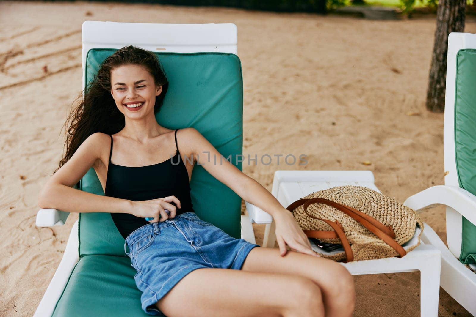 ocean woman young sand lifestyle lying girl sea travel vacation sunglasses rest sunbed resort resting summer beach smiling caucasian attractive sun
