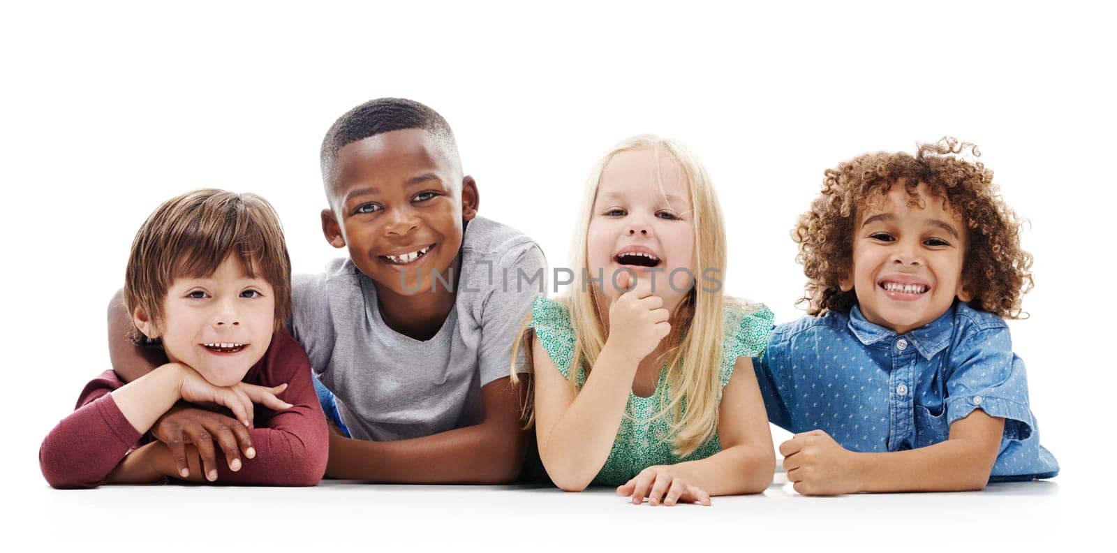Enjoying their playdate. Studio shot of a group of young friends lying on the floor together against a white background