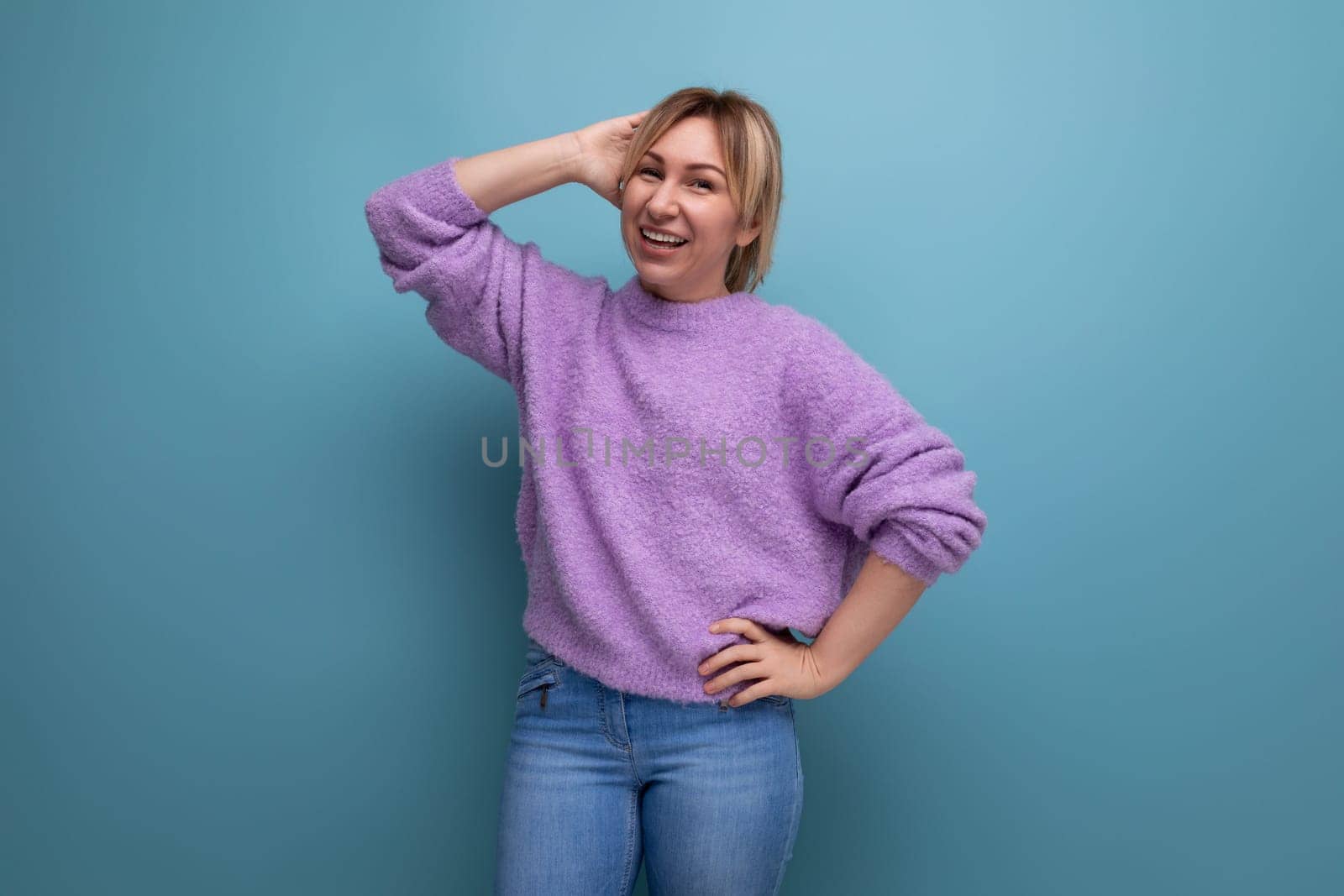 adorable blond young millennial woman in casual look posing as a model against bright background with copy space by TRMK