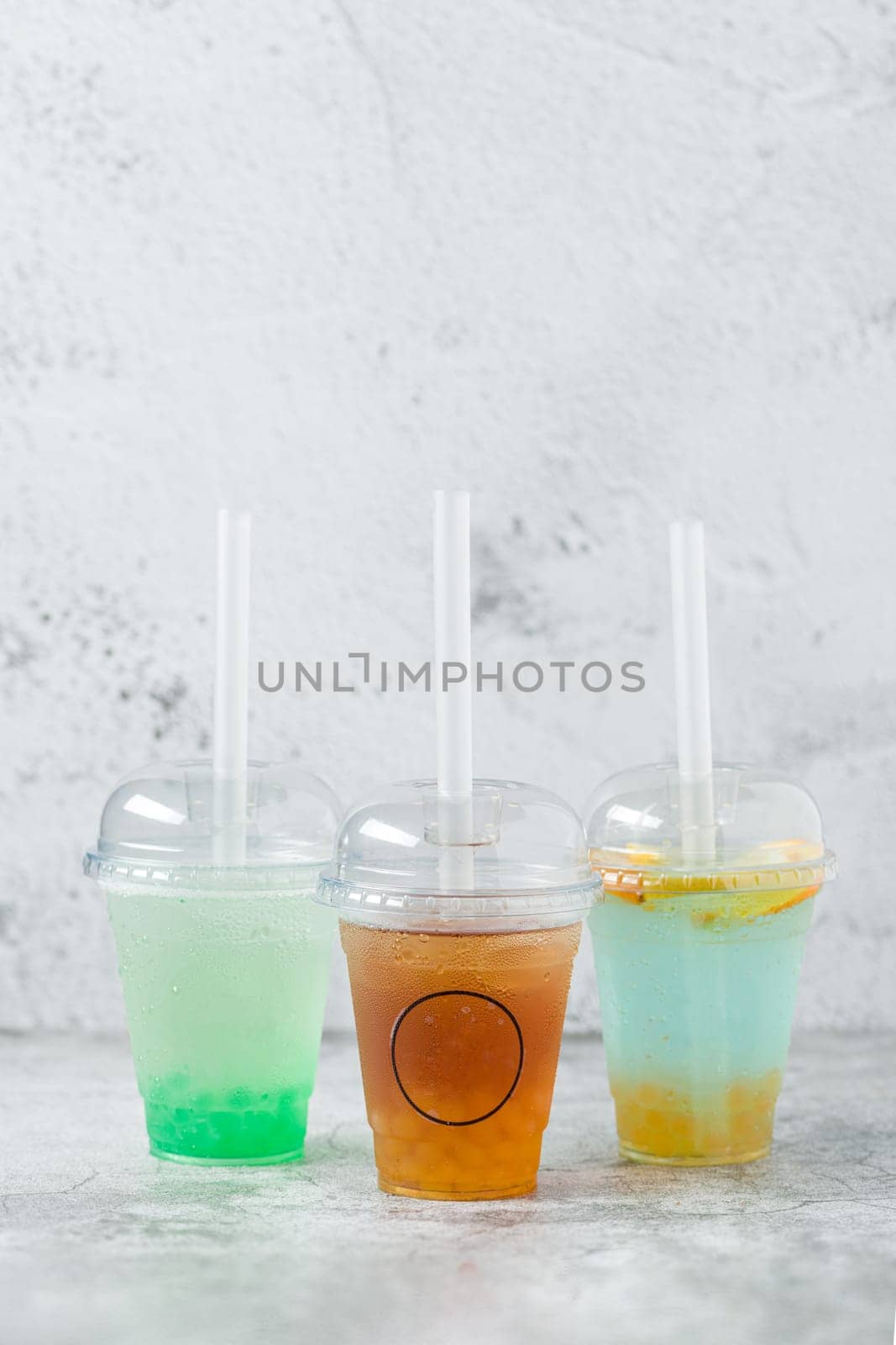 Fruity Bubble Tea in glass cup on gray background by Sonat