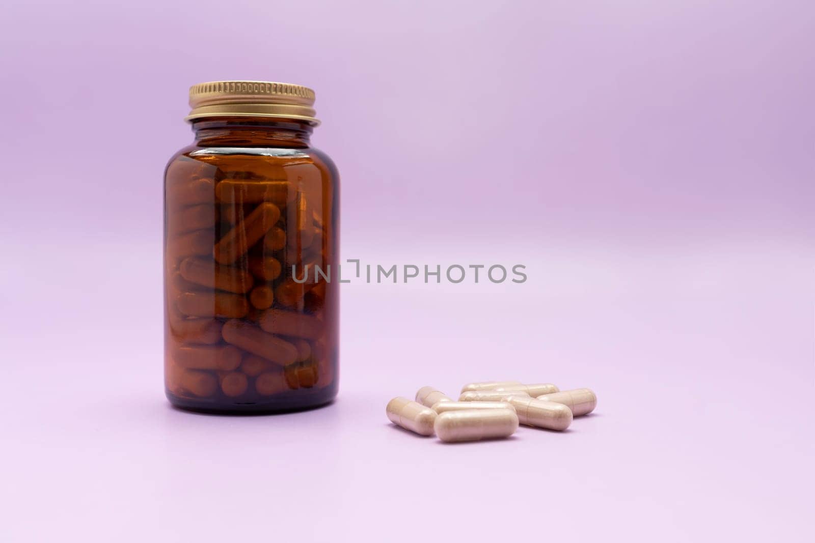 Brown Glass Bottle, Flattered Softgel Capsules OF Slippery Elm On Purple Violet Background, Herbal Supplement, Ulmus Fulva, Natural Remedy. Horizontal plane. Copy Space for Text.