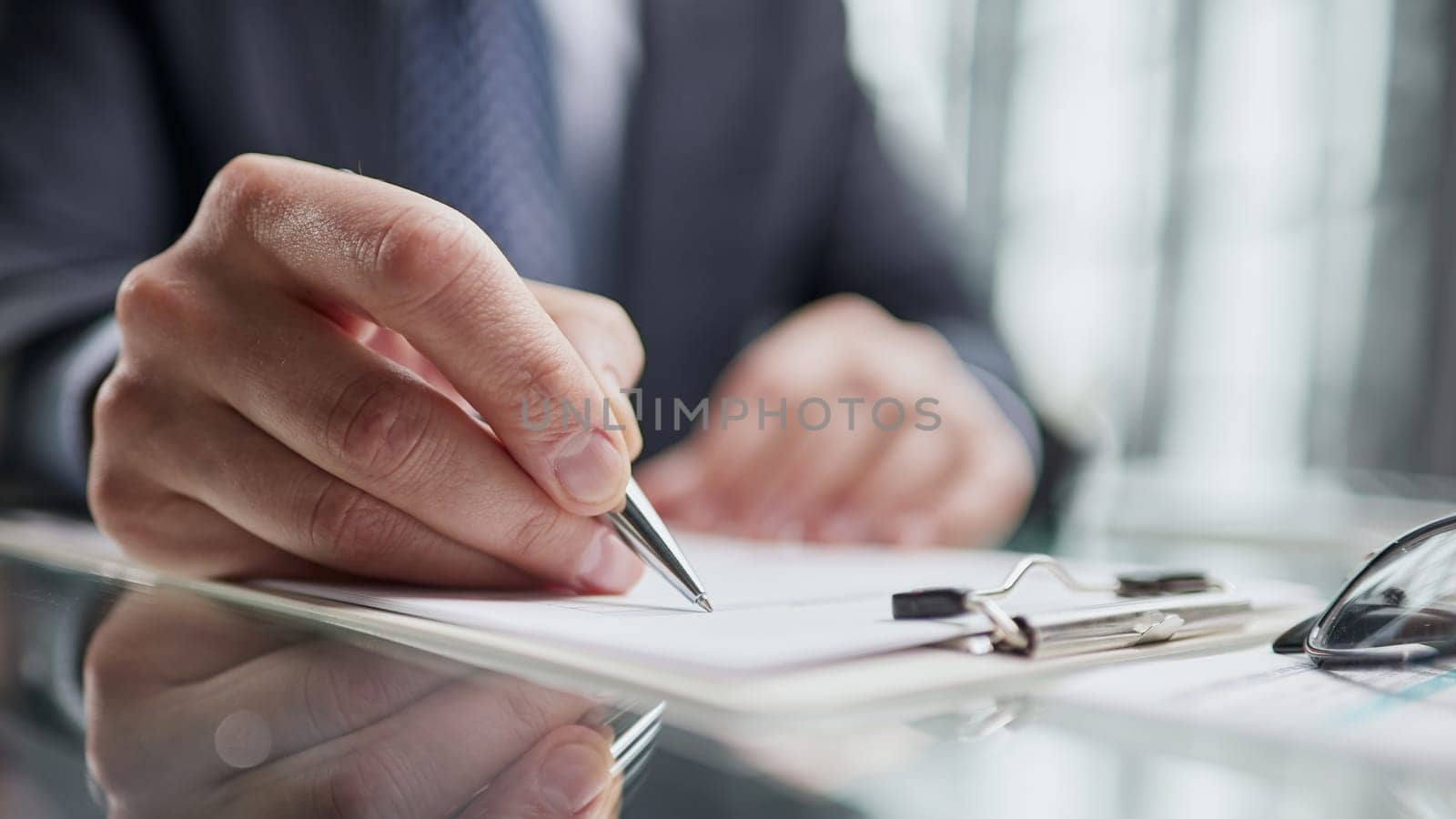man hands with pen writing on notebook in the office.learning, education and work
