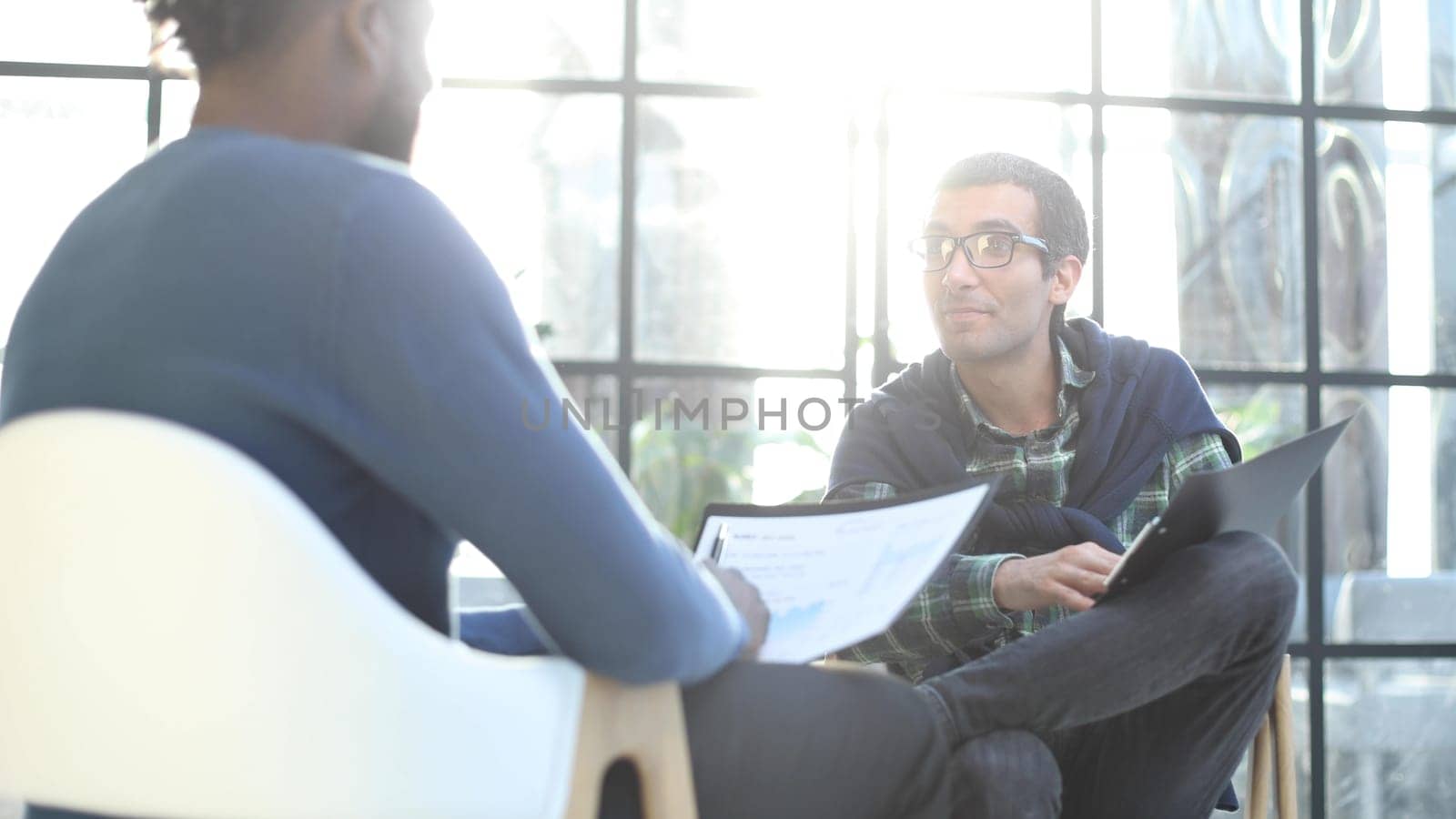 Positive young people fills in information in the questionnaire, applying for a job
