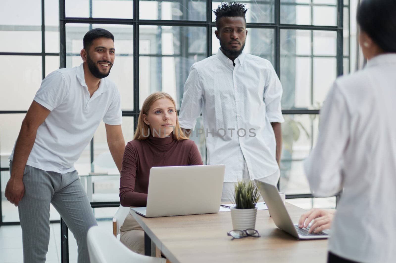 Businessmen and businesswomen talking during a meeting by Prosto