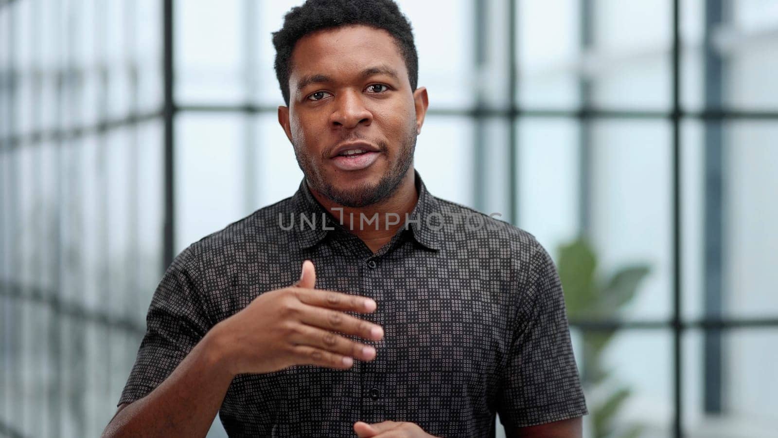 Indoor shot of a young confident black businessman looking serious
