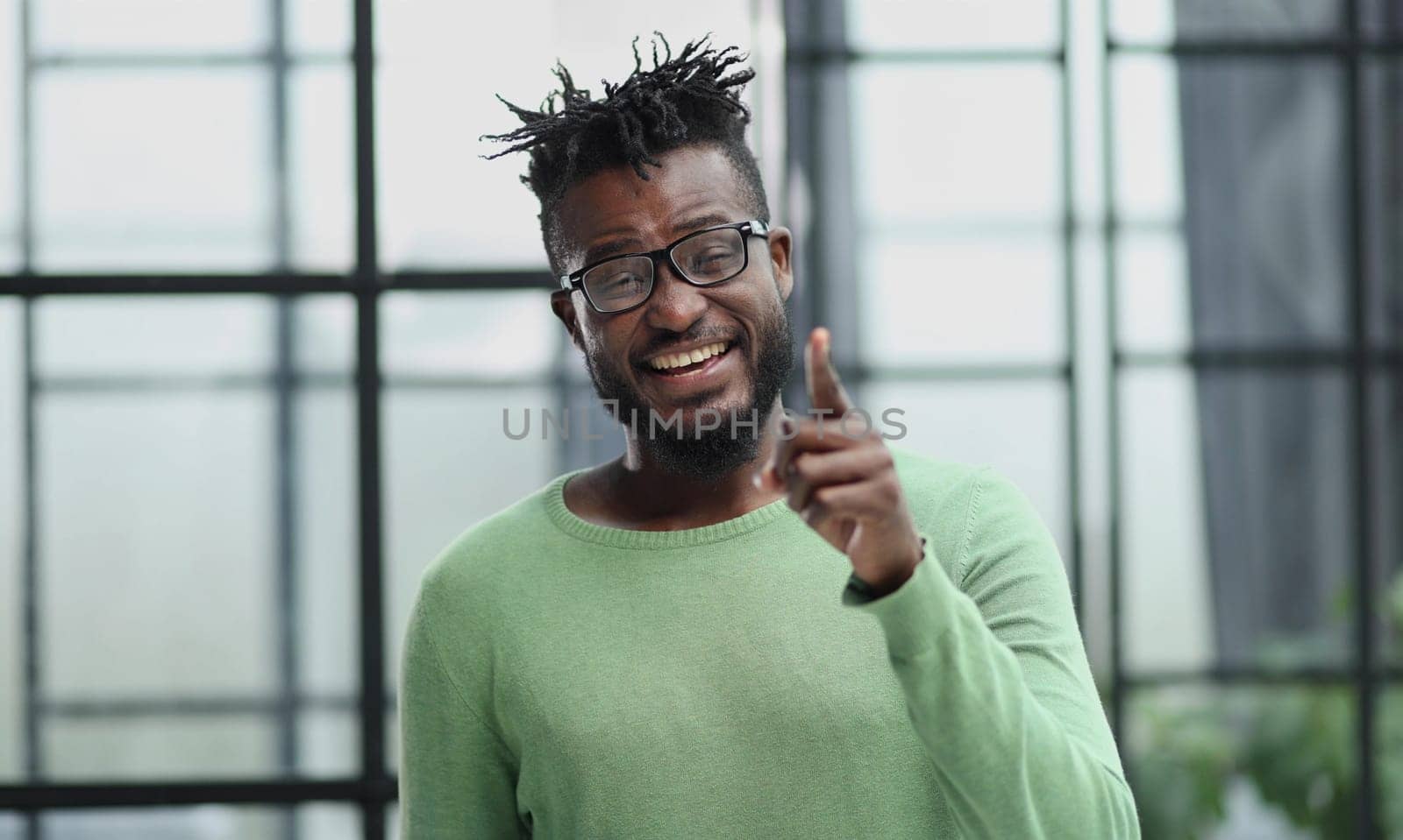 Young afro american worker man points finger at you with a confident expression