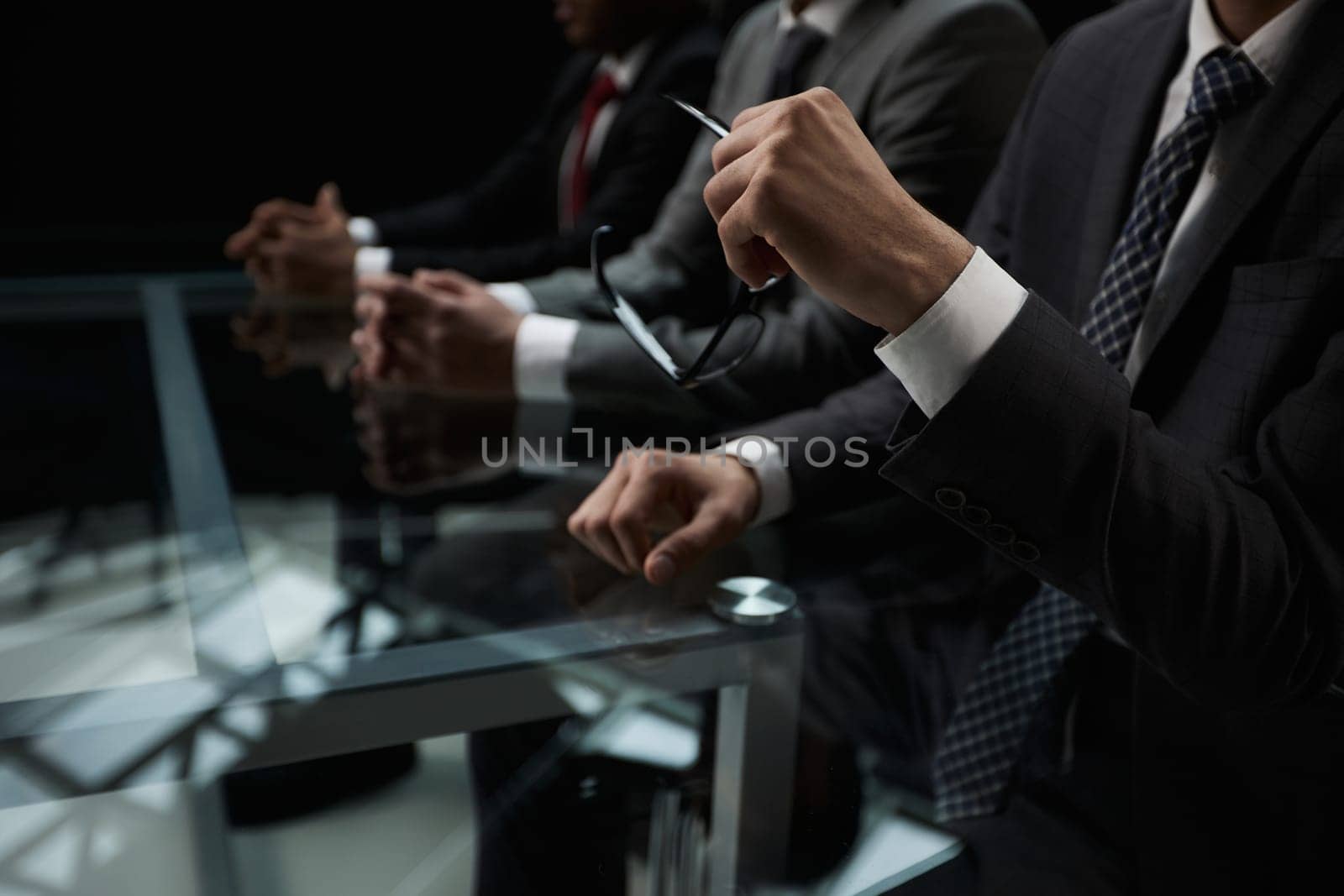 Business partners discuss financial reports, plan an investment strategy. Team of three