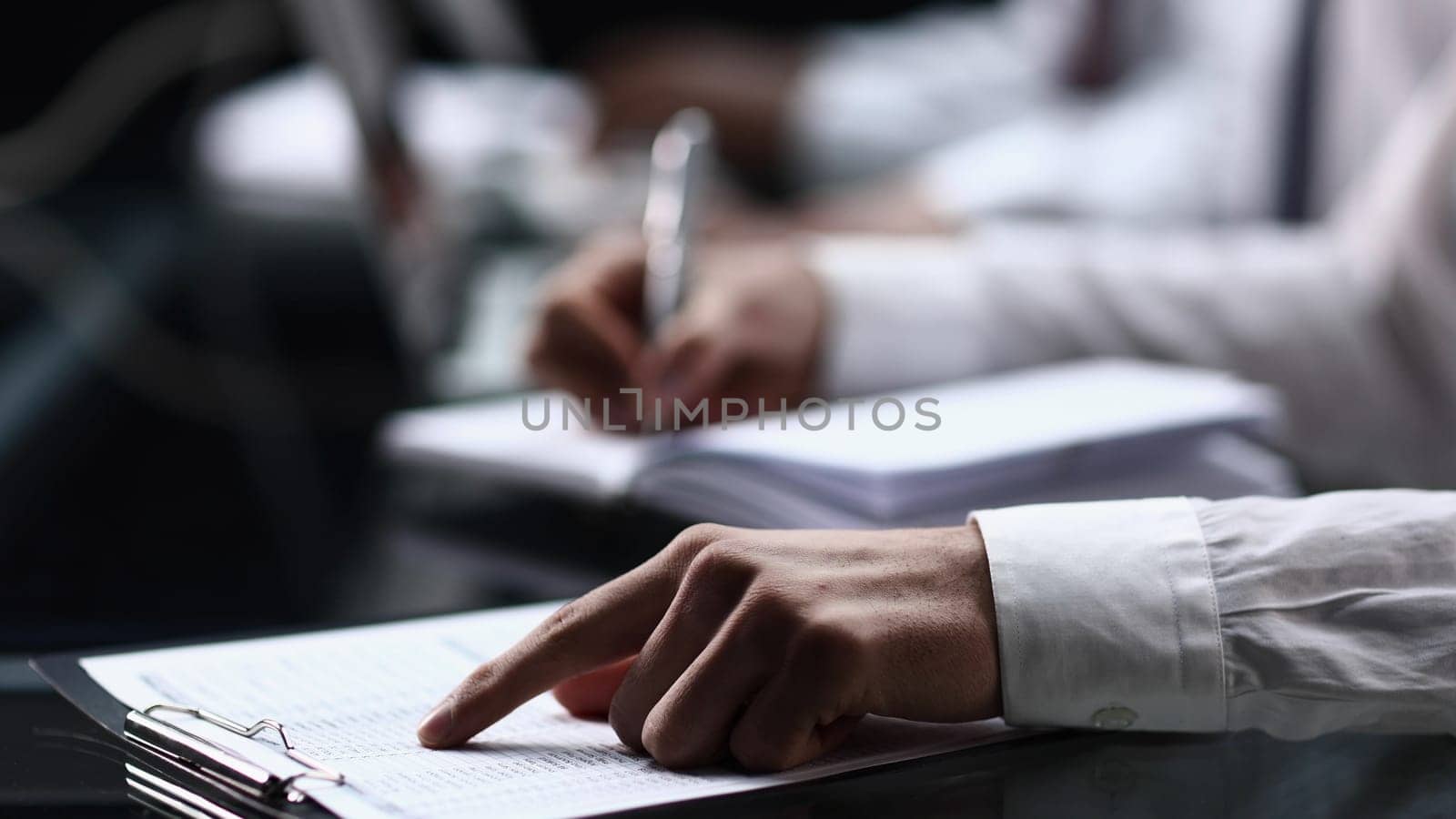 close-up of person filling out form or survey at office desk