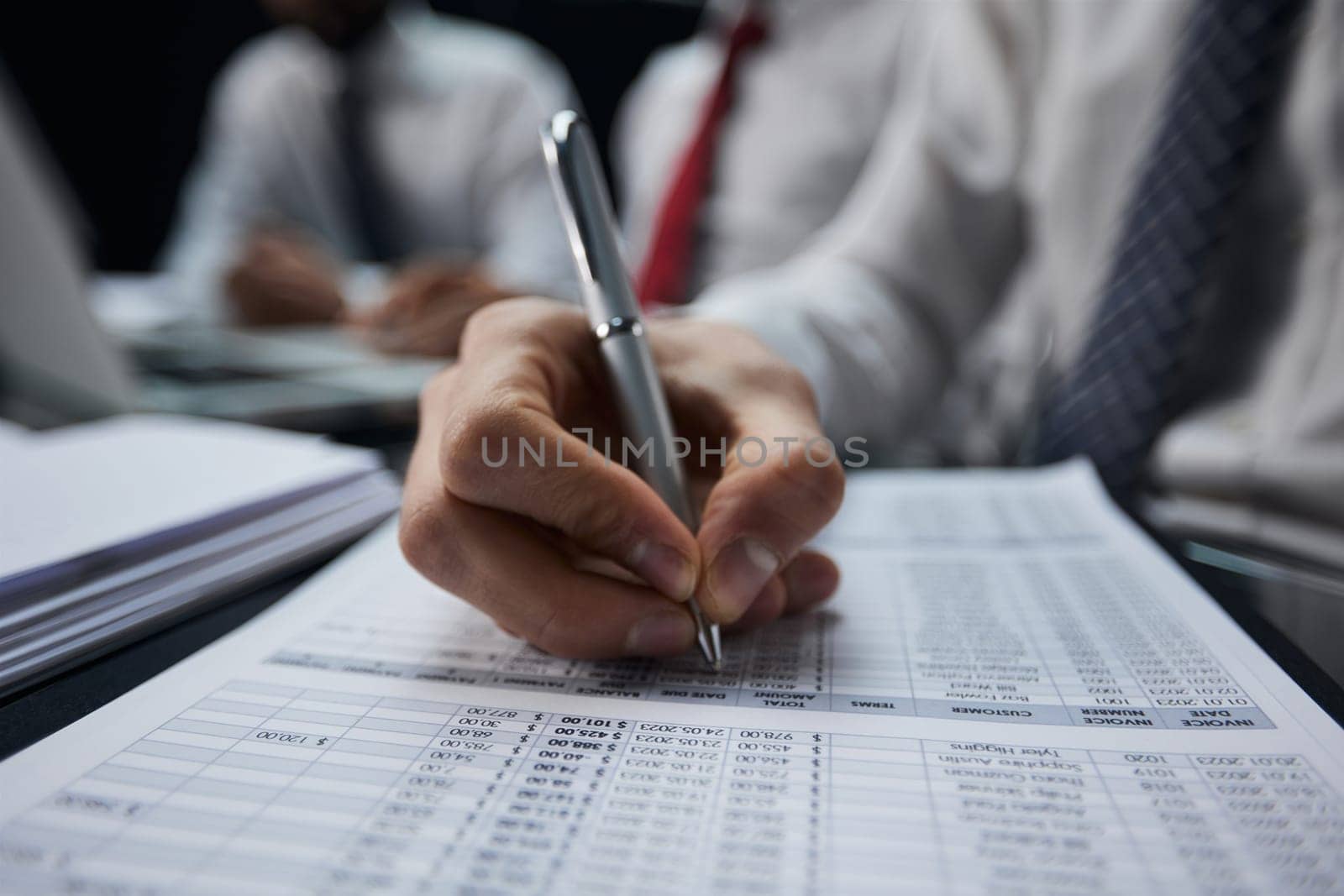 Businessman hand writing note on a notebook close-up. Business man working at office desk.