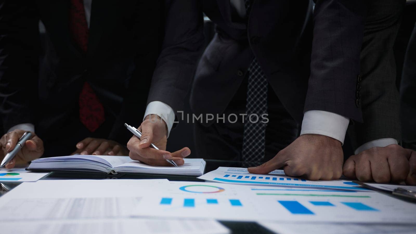 close-up. business colleagues look at the graph on the table from above