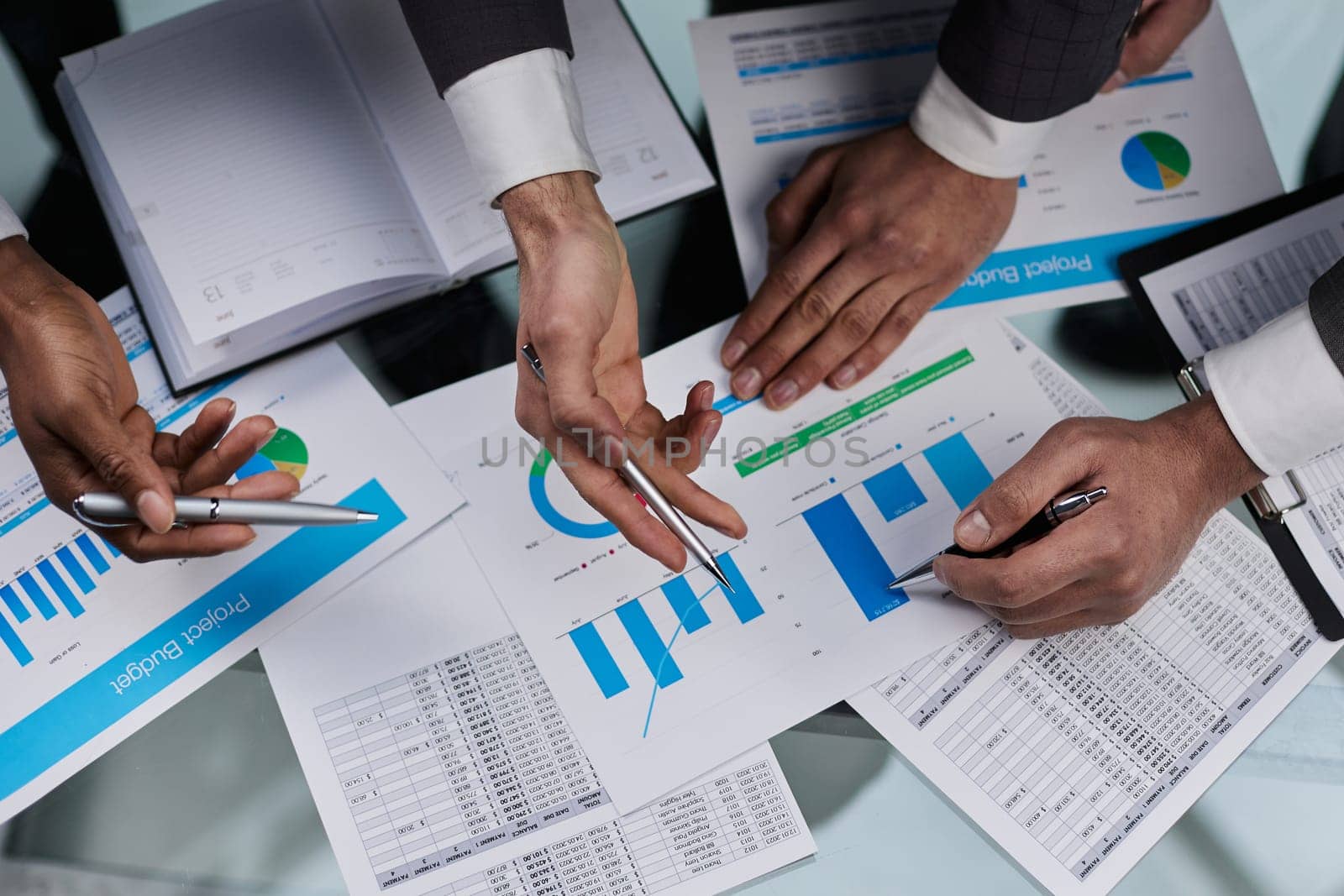 close-up. business colleagues look at the graph on the table from above