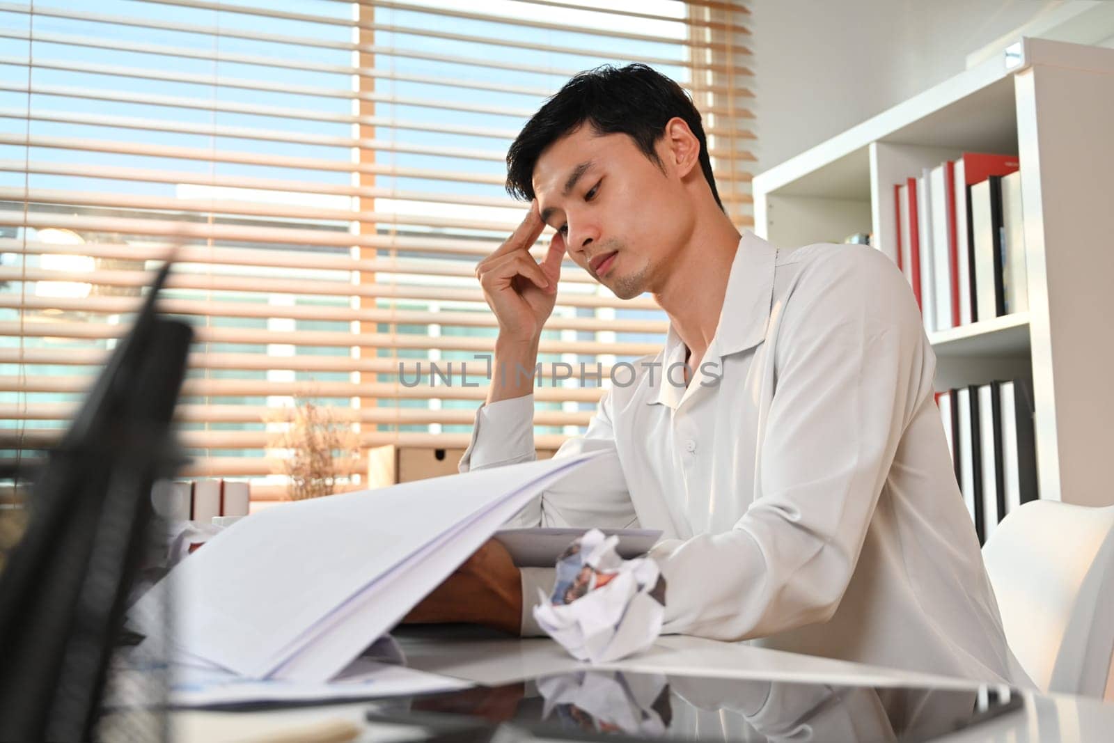 Stressed businessman thinking of problem solution stuck with task, frustrated about business failure in office