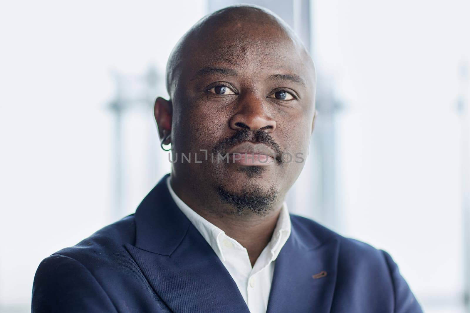 Handsome african american executive businessman in the office close up