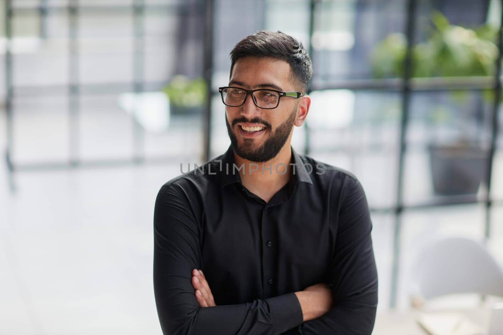 Businessman portrait. Happy confident young businessman standing , smiling, looking at camera.