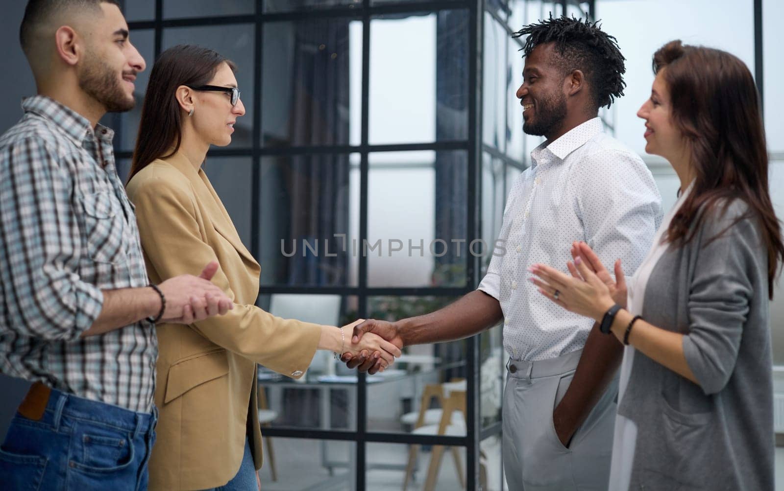 Businessman shaking hands with colleague after meeting in office