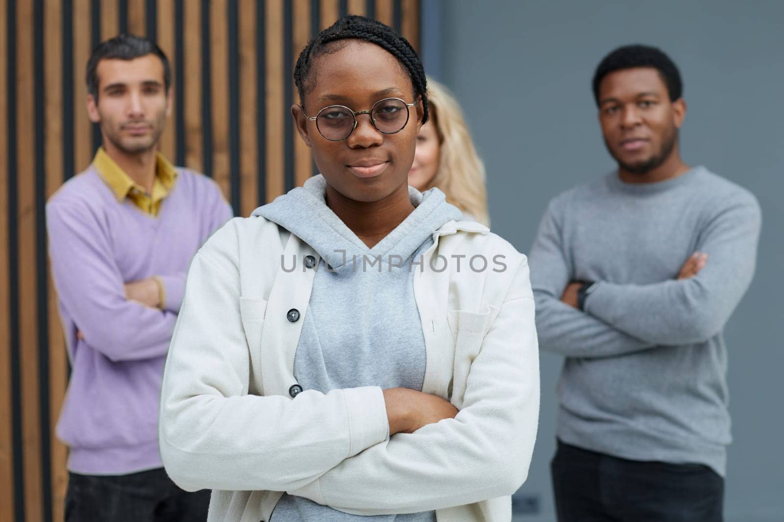 Attractive african american businesswoman standing with crossed arms in office