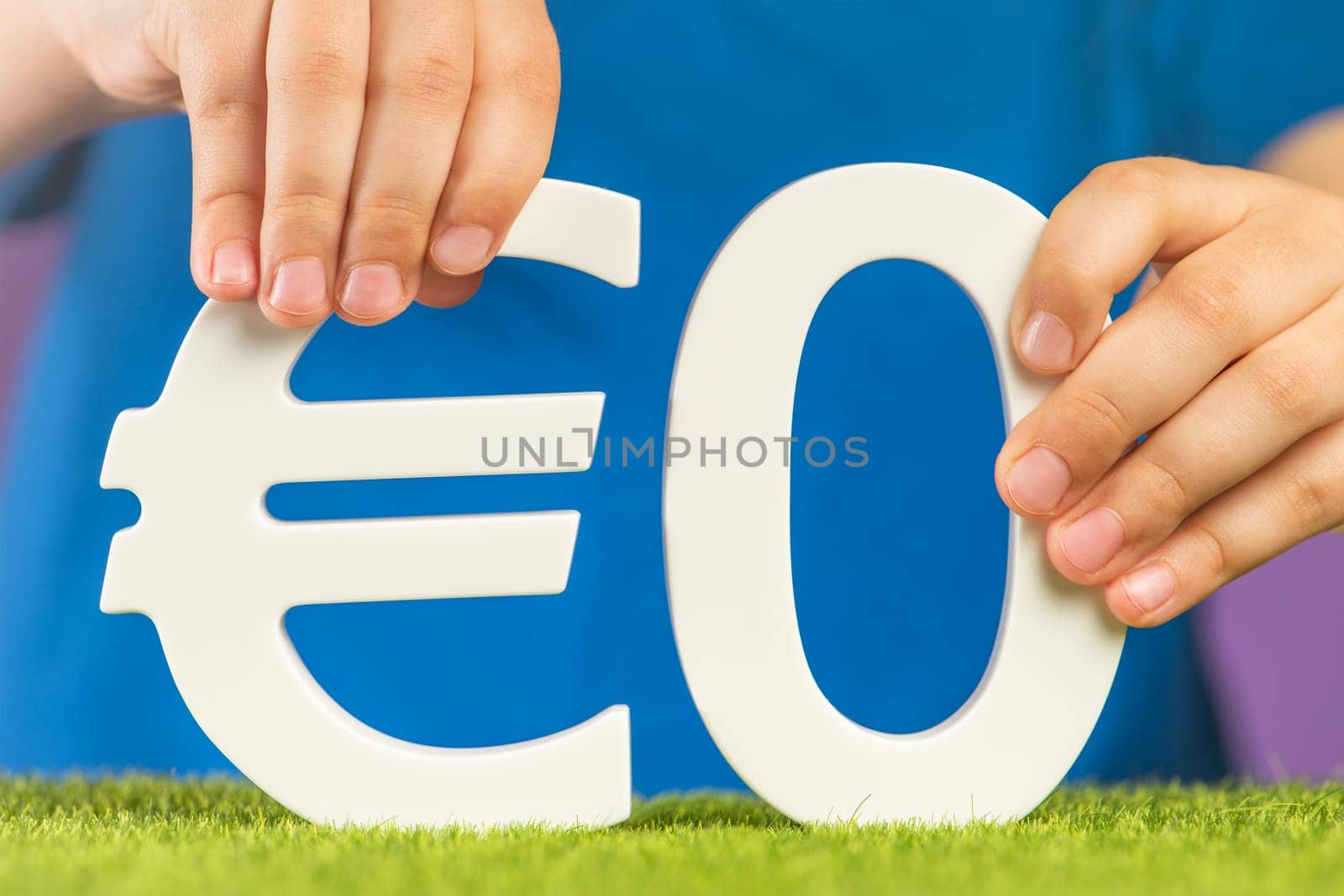 Zero interest rates in Europe. Zero cost or 0 euro in hand on a blue background. The concept of a company going bankrupt or devaluing something