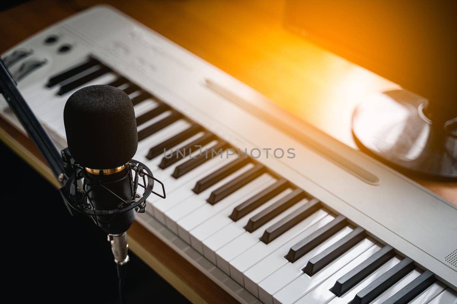 Close up of microphone and piano at the sound recording room