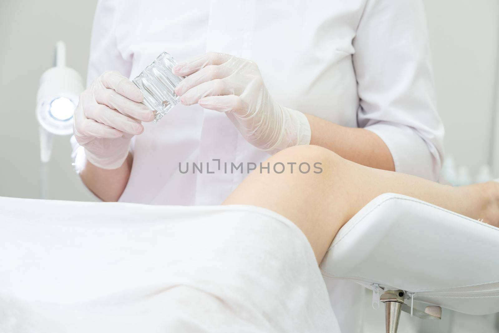 Gynecologist holding vaginal suppositories consulting patient