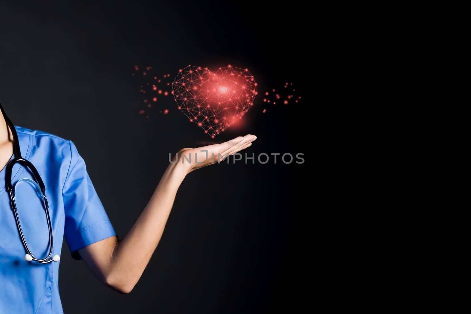 A doctor holds a glowing red heart in her hand. A nurse girl, a cardiologist shows the care for the patient, suggests remembering the need to maintain the health of the cardiovascular system.