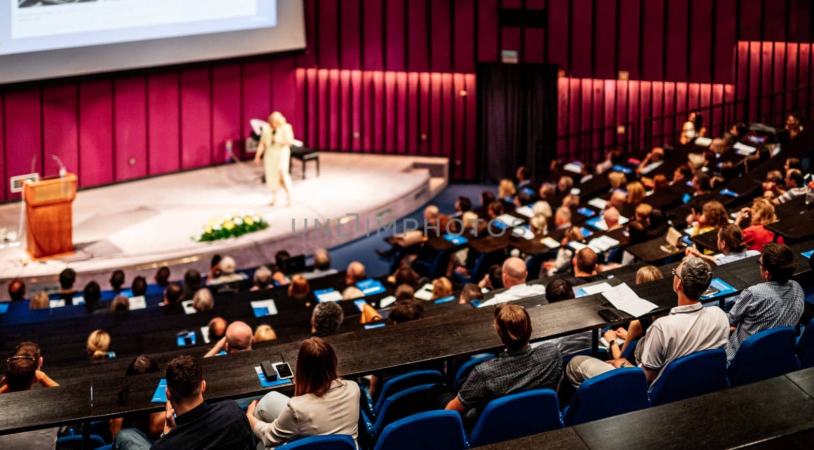 Woman giving presentation on business conference event. by kasto