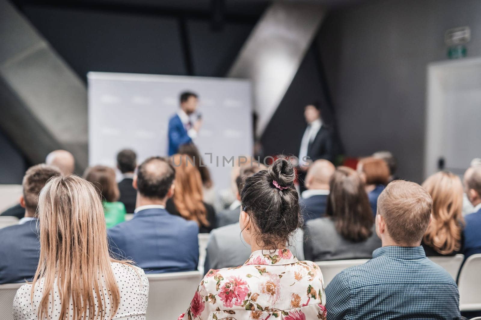 Pitch presentation and project discussion at business convention or team meeting. Audience at the conference hall. Business and entrepreneurship symposium. by kasto