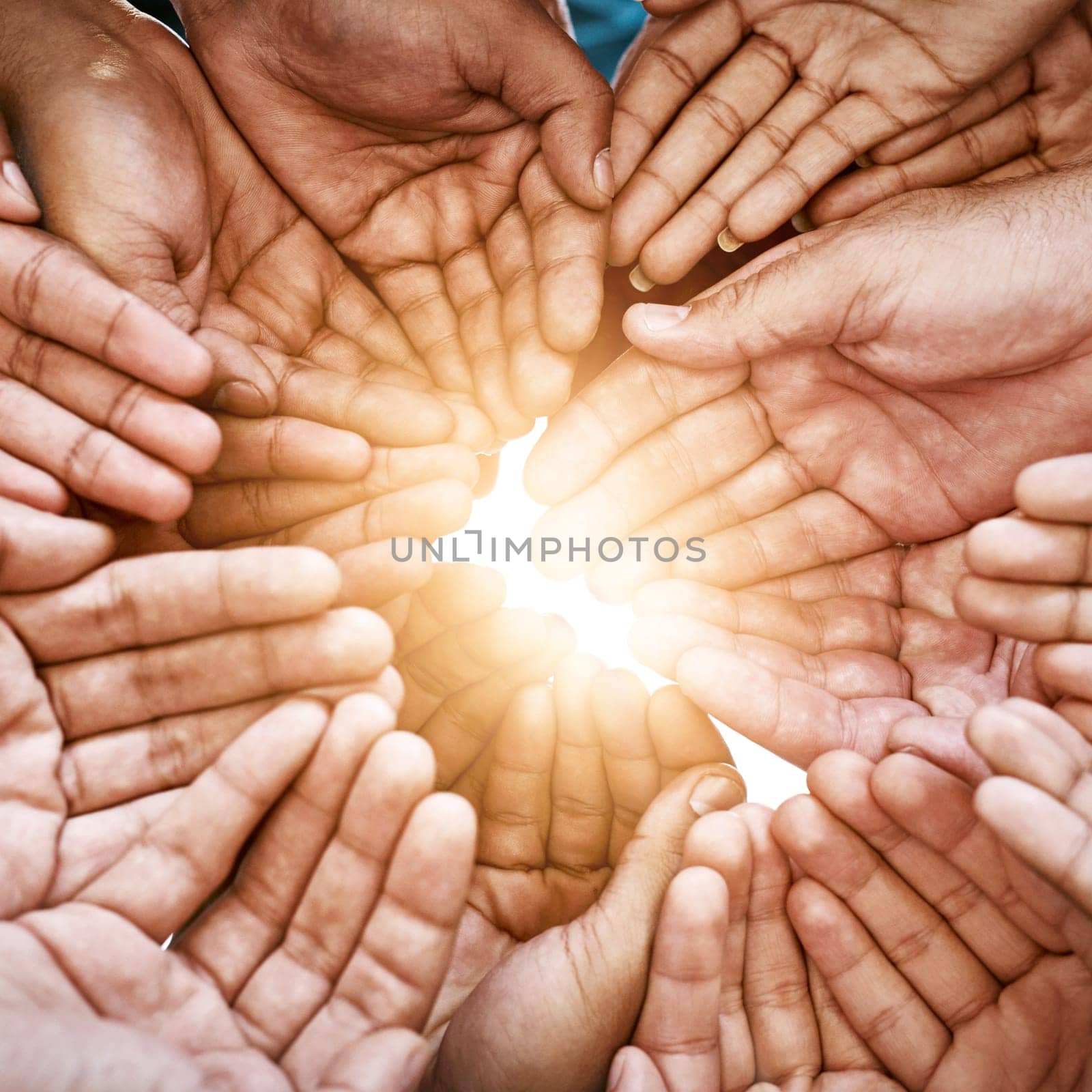 Closeup, hands and teamwork with collaboration, partnership and charity with sun flare. Group, people or volunteers with sunshine, friends and goals with help, hope and community with support or palm by YuriArcurs