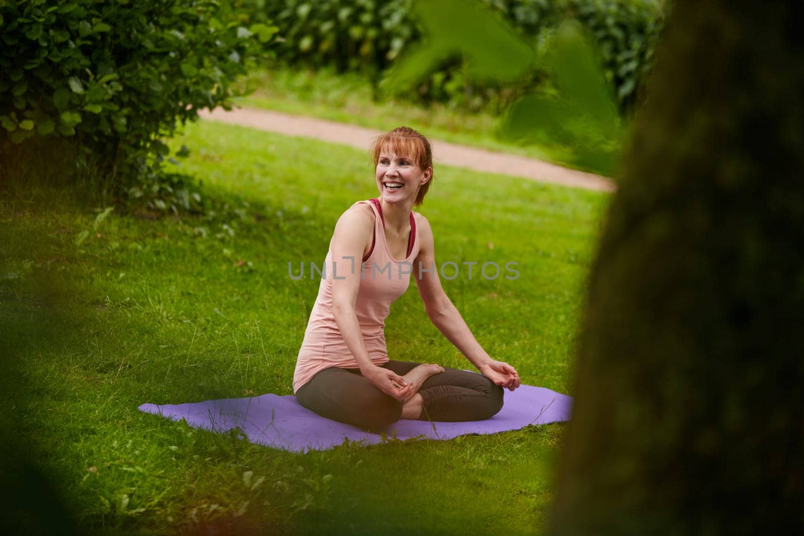 Yoga keeps her happy and healthy. a woman doing yoga in the park