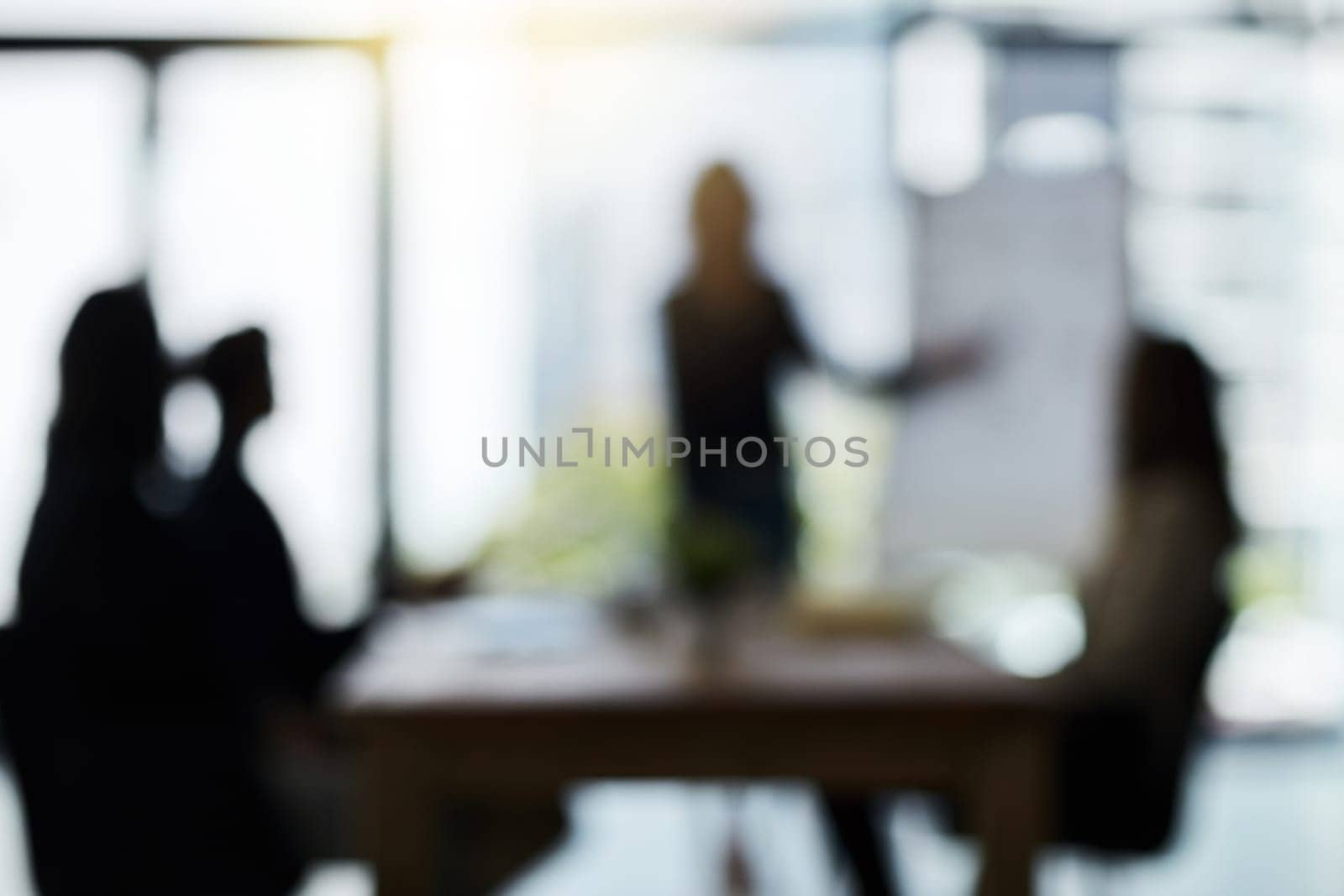 Silhouette, teamwork and blur of business people in meeting for discussion, planning and conversation. Corporate office, collaboration and men and women for presentation, communication and strategy by YuriArcurs