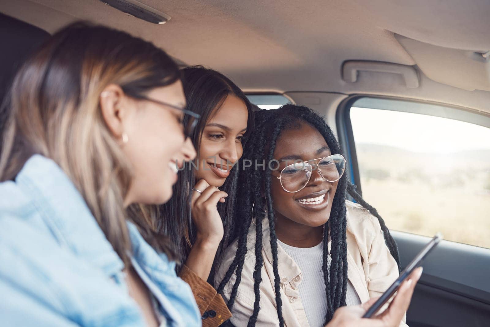 Travel, phone and friends with women in car for directions, adventure and journey. Gps, map and technology with girl driver and search online route for road trip, vacation and transportation together.