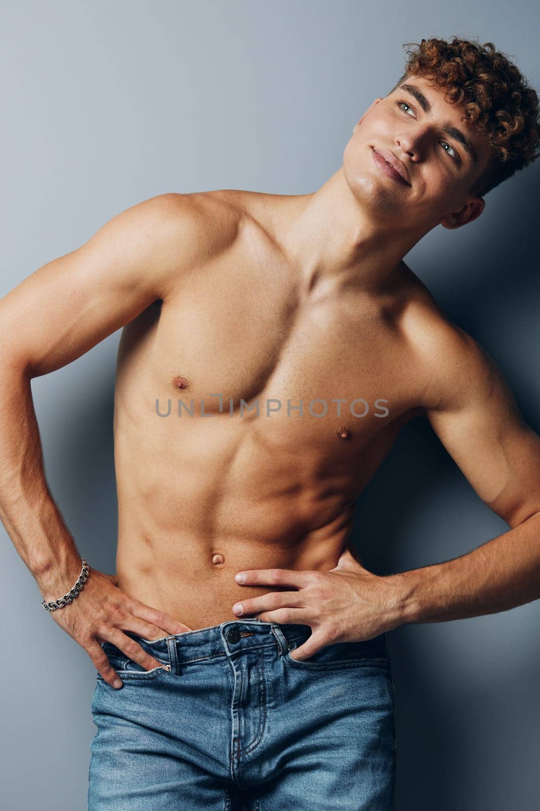 man attractive athlete standing healthy strong handsome torso fit abs muscular person bodybuilder curly smile background guy gray gray background