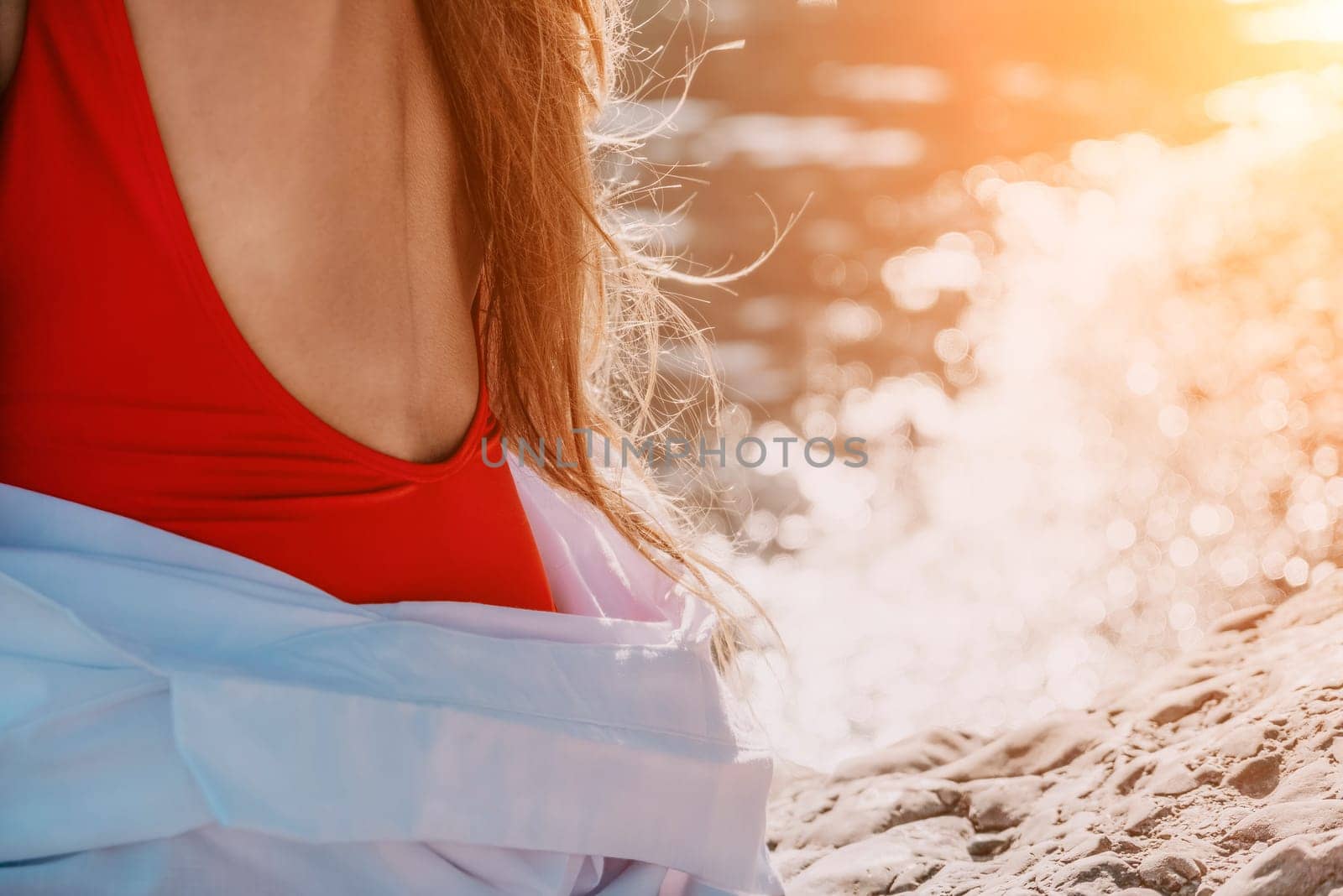 Sexy young woman in stylish bikini lying on seashore, closeup. Holiday, vacation and recreational concept.