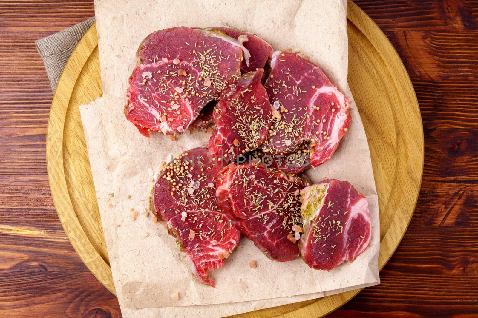 Raw Beef meat on old dark wooden table background, top view flat lay. Ingredients for delicious food. by darksoul72