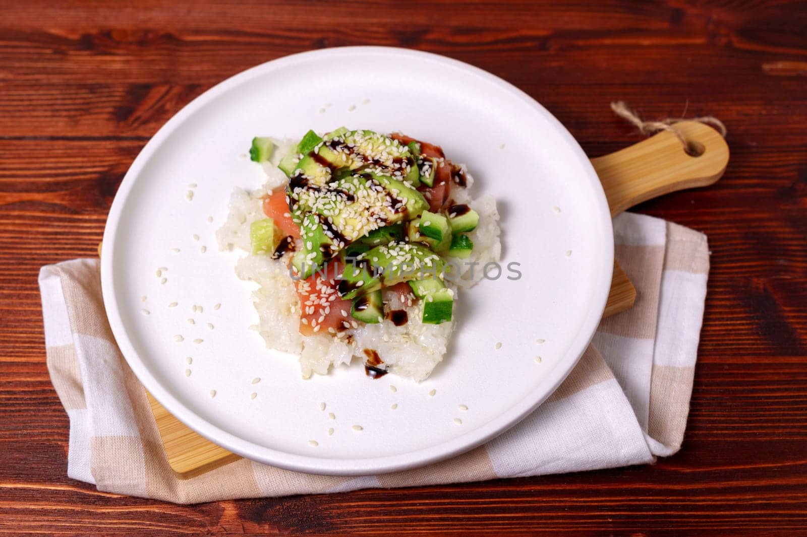 Sushi waffle is a cooking process. Culinary trend made with crispy rice waffles and sprinkled with salmon