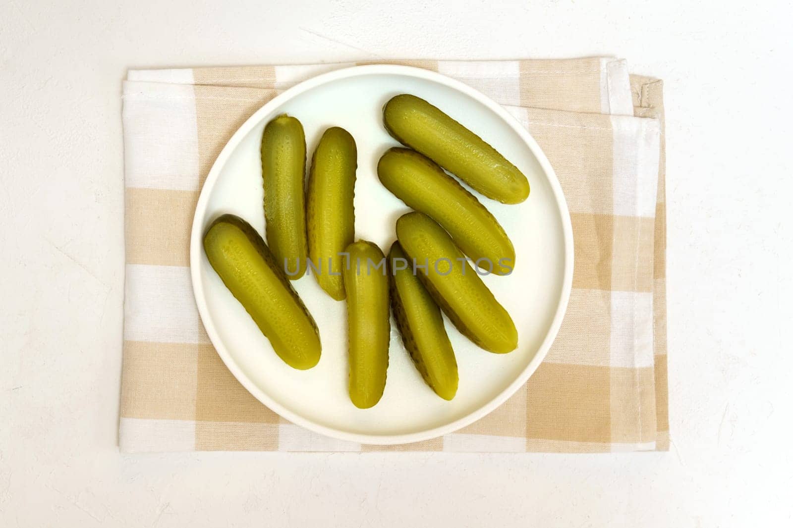 Pickled cucumbers, close up, culinary background. White background Selective focus