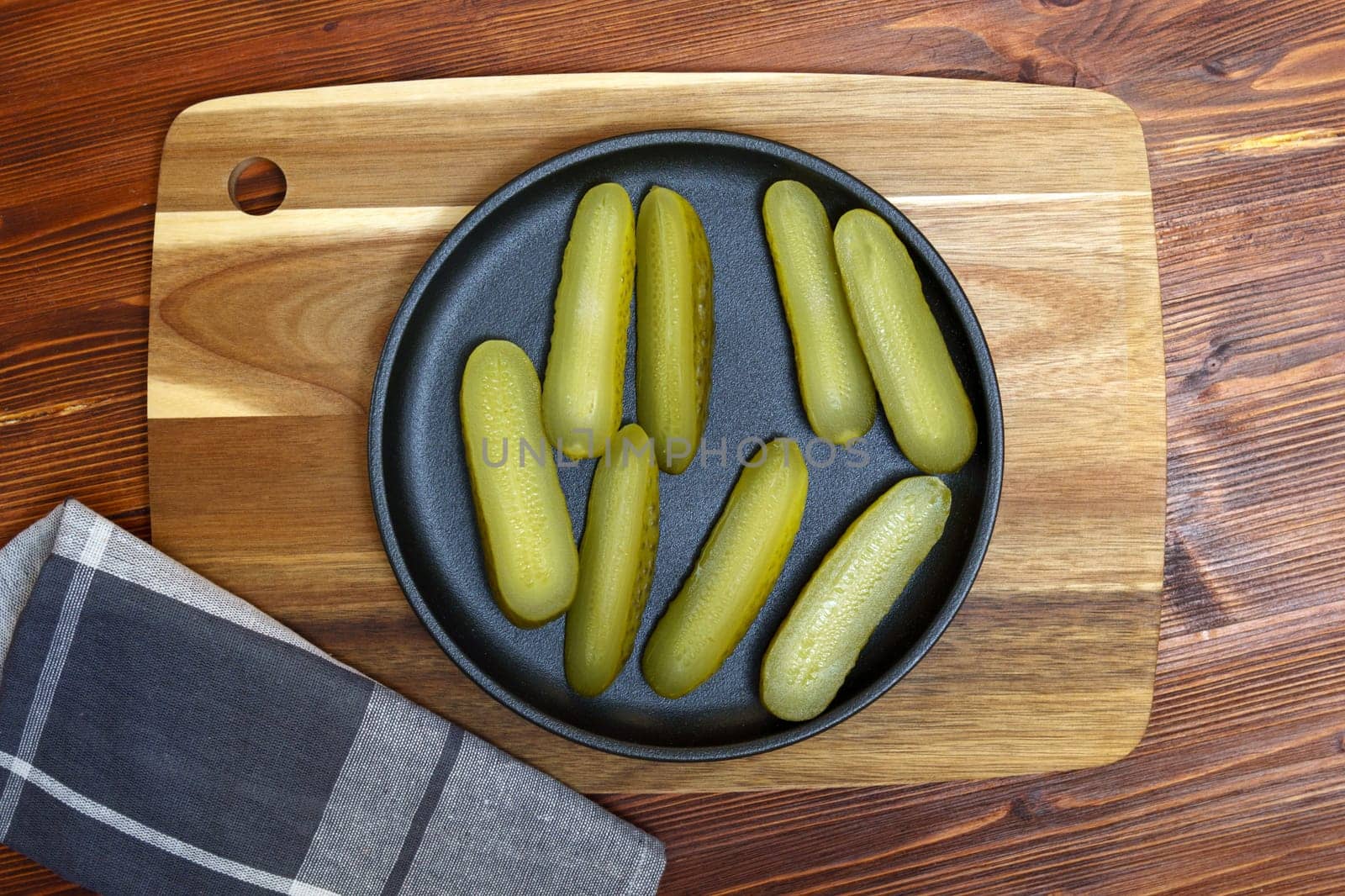 Pickled cucumbers, close up, culinary background. Wooden background Selective focus