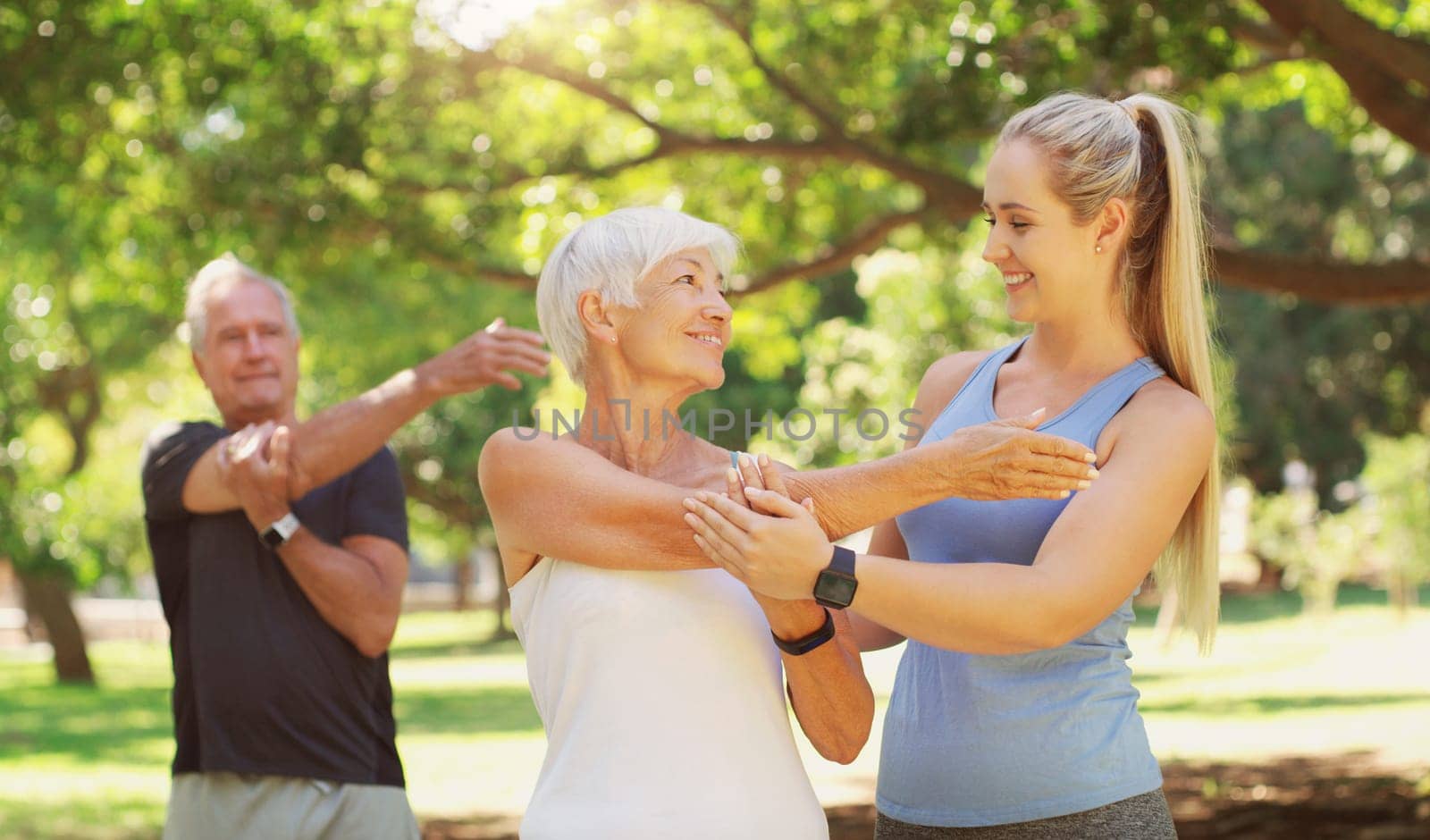 Yoga, workout and an old couple with their personal trainer in a park for a health or active lifestyle. Exercise, wellness or zen and senior people outdoor for fitness class with their pilates coach.