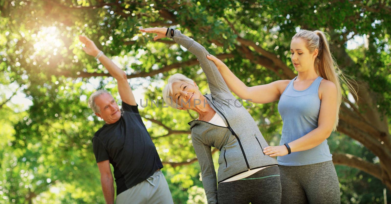 Yoga, fitness and an old couple with their coach in a park for a health or active lifestyle. Exercise, wellness or zen and senior people training outdoor for a workout with their personal trainer.