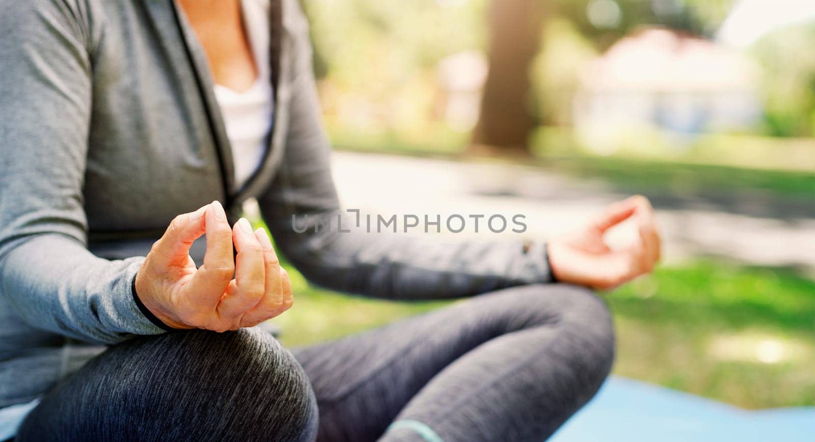 Woman outdoor, yoga and meditation with lotus pose, fitness in park with zen and spiritual healing. Female person hand, exercise in nature and meditate for health with wellness and mindfulness by YuriArcurs
