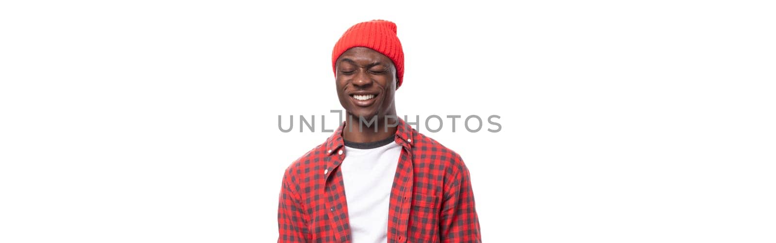 panoramic photo of a confident young ethnic african guy in a stylish look isolated on a white background.