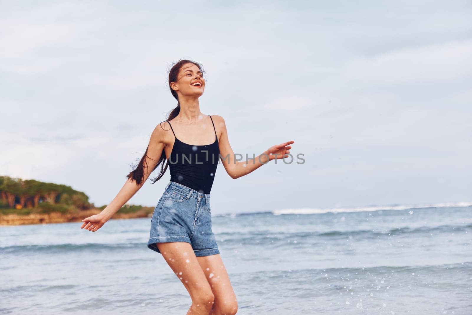 smiling woman carefree running tan fun sunset summer body young sunrise vacation travel girl beach hair person long smile lifestyle shore sea